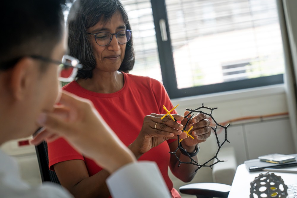 PhD student Wanzhuo Shi and Professor Latha Venkataraman examine a toy model of a single-molecule magnet.